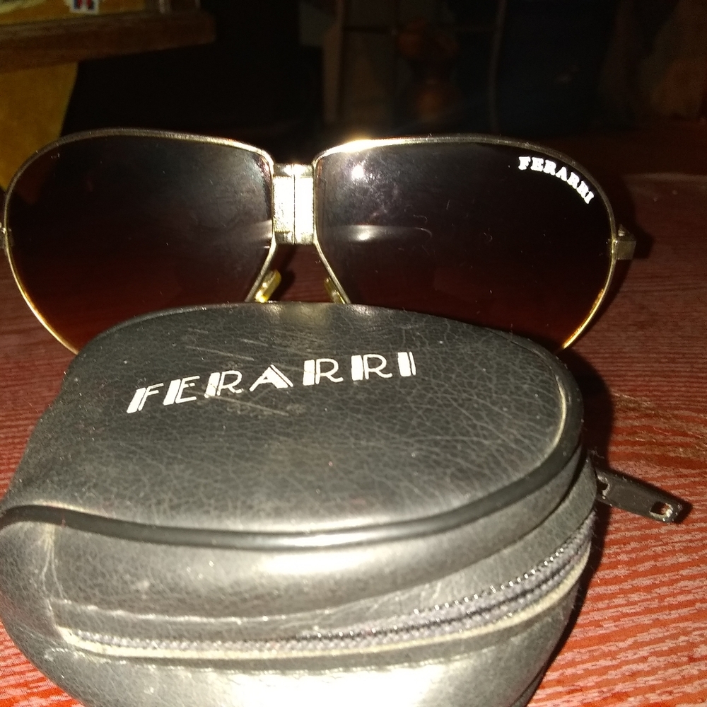 Vintage Ferarri Sunglass brown with a gold trim an
